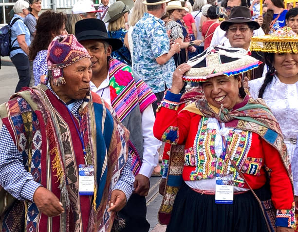 Santa Fe, NM: Cheerful Peruvian artists in traditional dress at the Folk Art procession at the Santa Fe Railyard plaza. The procession kicks off the annual International Folk Art Market (IFAM), where folk artists from over 50 countries participate.