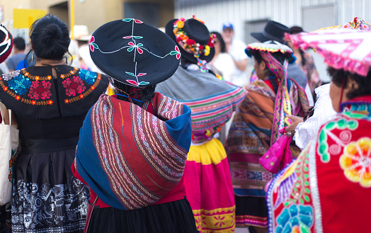 Santa Fe, NM: Rear view of Peruvian artists in traditional dress at the Folk Art procession at the Santa Fe Railyard plaza. The procession kicks off the annual International Folk Art Market (IFAM), where folk artists from over 50 countries participate.