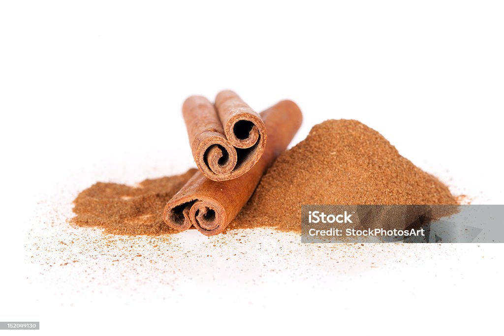 Ground cinnamon and sticks Ground cinnamon and sticks isolated on a white background Brown Stock Photo