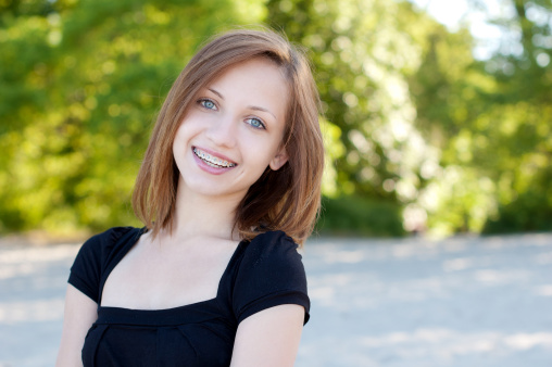 Beautiful girl wearing braces, candid portrait