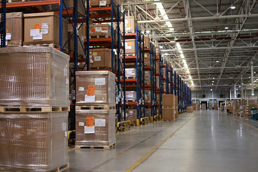 Warehouse industrial and logistics companies. Commercial warehouse. Huge distribution warehouse with high shelves. Low-angle view.