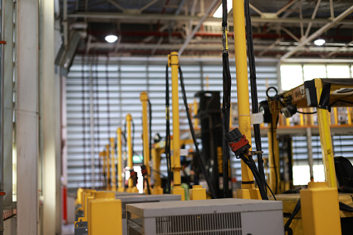 The station of the Electrical forklift charging battery inside of a logistic warehouse. The alternative energy source for cars and machines in the industrial business segment. Automotive technology. Battery Charger for electric forklift, Warehouse logistics, Import export.