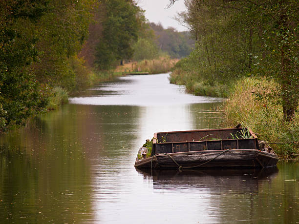 Old vintage agricultural peat barge in a dutch natural canal