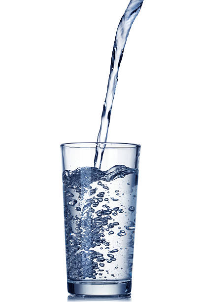 istock water pouring into glass isolated on white 152055255