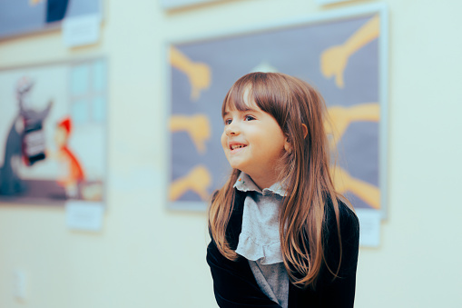 Cheerful toddler child having fun at the museum