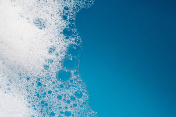 istock Detergent foam bubble on water. Blue background, Soap sud 1520853282