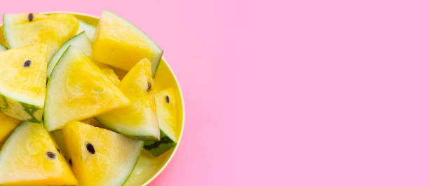 istock Yellow watermelon slices on pink background. 1520855389