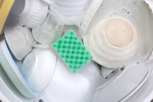 istock Dishes and bowls in water and bubbles of dishwashing liquid. Kitchen work 1520926761