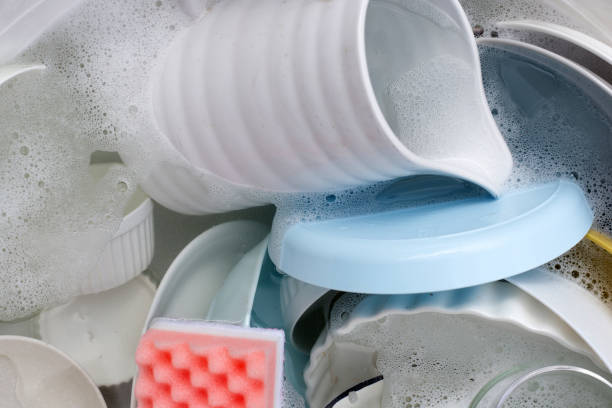 istock Dishes and bowls in water and bubbles of dishwashing liquid. Kitchen work 1520927801
