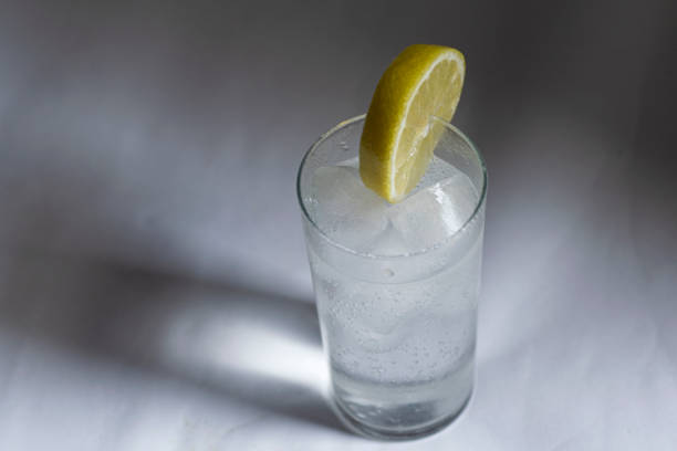 Gin tonic with lemon slice on the table