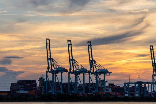 Norfolk Virginia - July 4 2023: Cranes and Shipping Containers at Norfolk International Terminal Port of Virginia During Sunset on the Elizabeth River