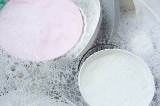 istock Dishes and bowls in water and bubbles of dishwashing liquid. Kitchen work 1520975093