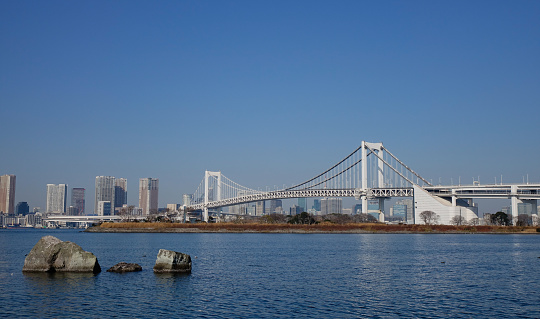 Tokyo, Japan - Jan 4, 2016. View of Tokyo Bay with Rainbow Brigde in Tokyo, Japan. Tokyo Bay is connected to the Pacific Ocean by the Uraga Channel. Its old name was Edo Bay.