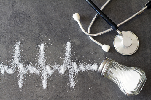 Salt shaker, stethoscope, cardiogram made of salt, hypertension concept idea