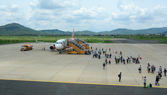 Dalat, Vietnam - May 20, 2016. An airplane with passengers at the Lien Khuong Airport in Dalat, Vietnam. Dalat is located 1,500 m (4,900 ft) above sea level on the Langbian Plateau.
