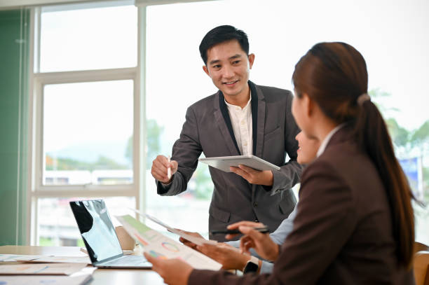 istock A professional Asian male boss sharing his ideas and discussing work with his employees 1521089845