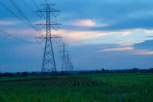 Photo of High-voltage pylons supply electricity to areas outside the city. beautiful sky