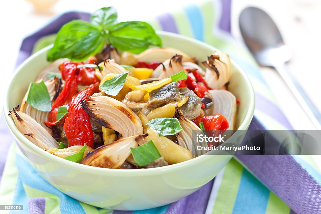 Colorful salad made from baked vegetables Vegetable salad in the bowl over stripped napkin Baked Stock Photo