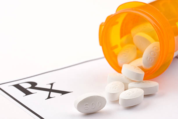 istock Prescription tablets spilling from an orange container 152110776