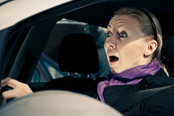 istock Young woman screams while driving a car 152110852