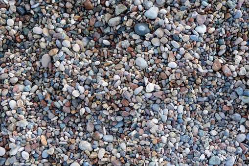 Crushed stone on the seashore. Selective focus on object. The stones were laid on the ground in the garden as a background. Background blur. Pebble stones background.