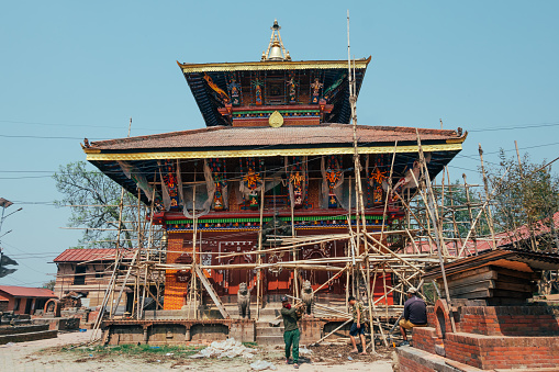 Bhaktapur, Nepal - Apr 16, 2023: Workers working on the restoration process of the Changu Narayan, a historic Hindu temple, is situated in the Changunarayan Municipality of Bhaktapur.