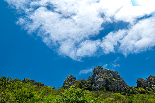 stone mountain on blue sky background, Grey Stone mountain view on the sky background, Stone hill, small hill on the blue sky background .