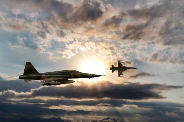 istock Jet aircrafts flying over the clouds at sunset. 1521125740