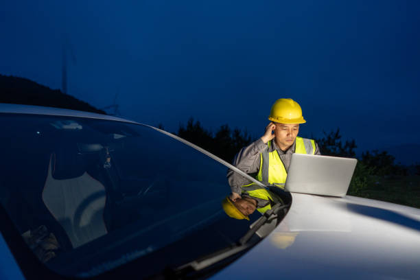 istock A male engineer is working overtime with a laptop next to a car 1521126246
