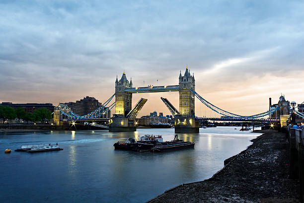 Tower Bridge at dusk Opened Tower Bridge at sunset, London opening bridge stock pictures, royalty-free photos & images