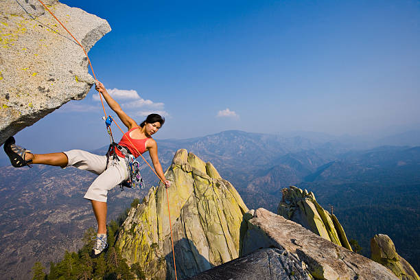 istock Female rock climber rappelling. 152112945