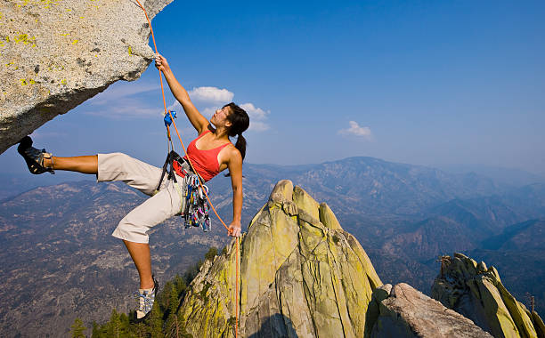 istock Female rock climber rappelling. 152112957