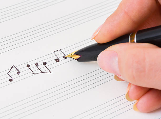 istock Hand writing musical notes with pen on a music sheet 152113469