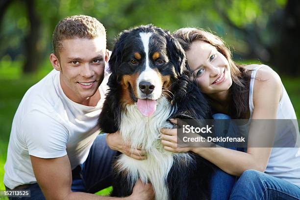 Young Couple Holding A Large Dog Stock Photo - Download Image Now - Adult, Affectionate, Animal
