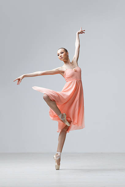 istock Ballet dancer in pink dress on gray background 152114242