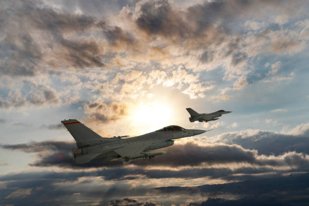 istock Jet aircrafts flying over the clouds at sunset. 1521144279
