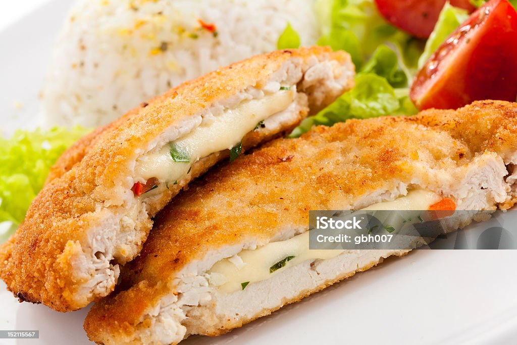 Fried stuffed turkey fillet with cheese Fried stuffed  turkey fillet with cheese, white rice and vegetables Chicken Breast Stock Photo