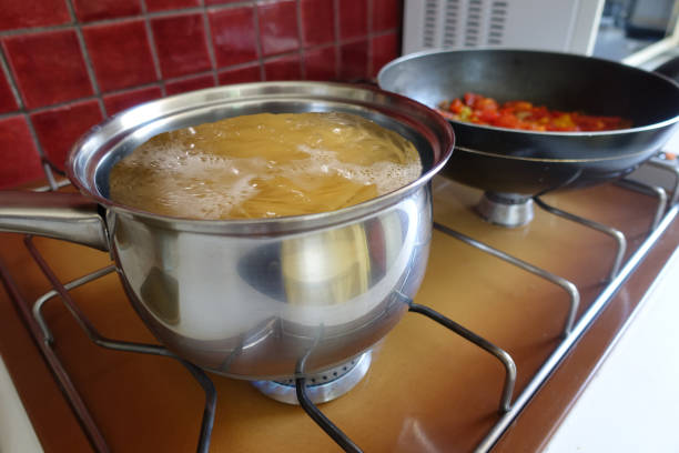 istock Spaghetti being cooked in boiling water  Tomato sauce being prepared 1521159164