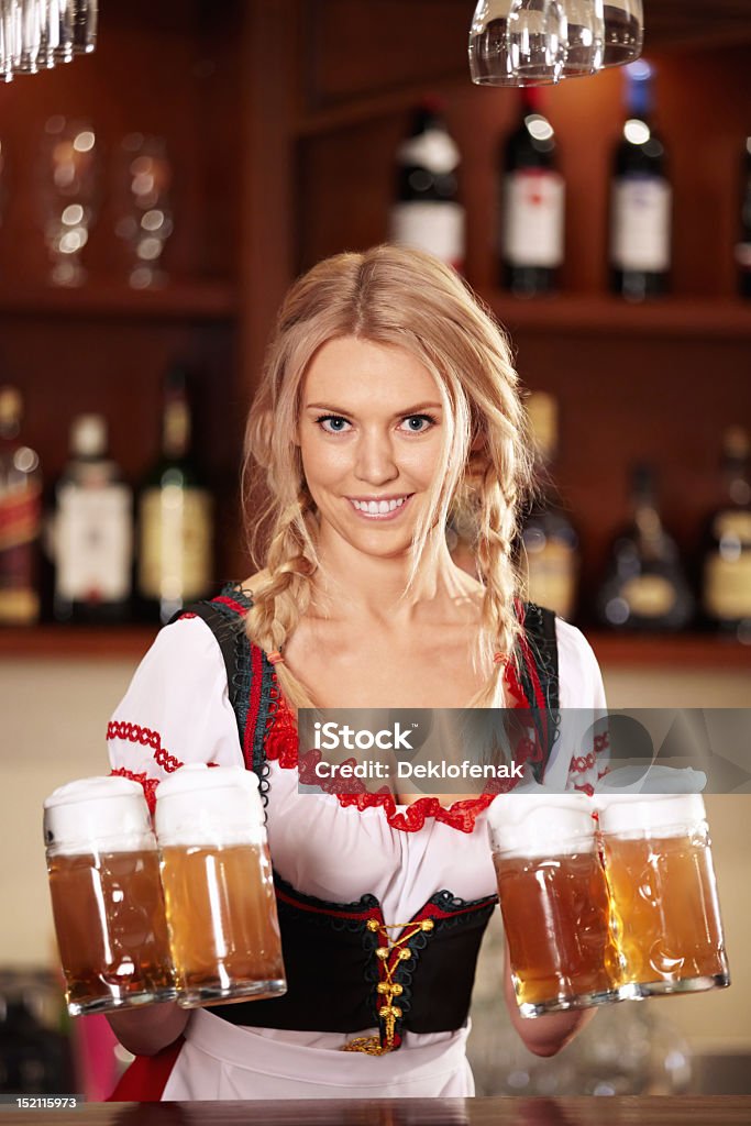 A woman holding jugs of beer at the bar http://content.foto.mail.ru/mail/deklo-design/2/i-34.jpg Nightclub Stock Photo