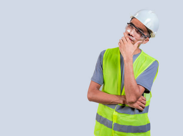 istock Thoughtful engineer on isolated background. Engineer man with hand on chin thinking 1521169442