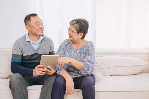 istock Happy senior couple enjoys technology together at home sofa. Tablet for elderly couples Strengthen family bonds with modern technology.Tech savvy husband and wife benefits of device for seniors. 1521174670