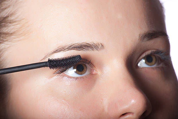 istock Beautiful woman putting make up on eye 152117565