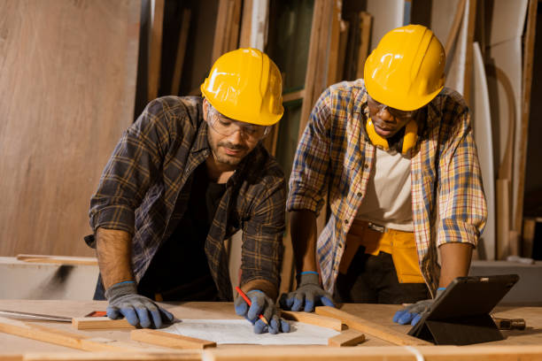 istock engineer wooden home builder working together consulting with plan design to build or renovate with wood material. 1521175721