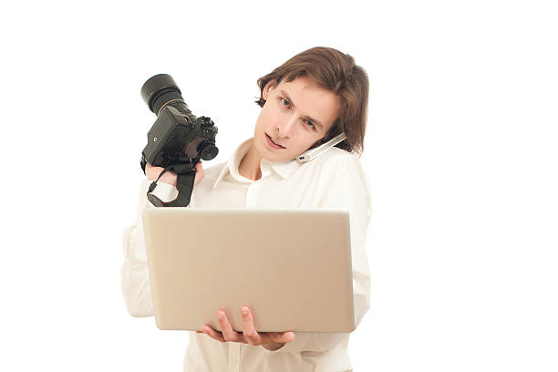 istock photographer holds camera and laptop 152118394