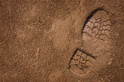 Imprint of the shoe on mud with copy space