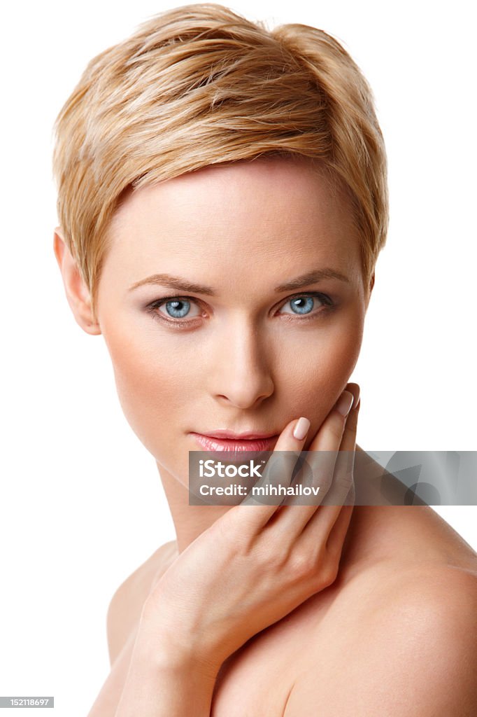 Close-up of blue-eyed blonde woman with hand on face Closeup portrait of young caucasian woman with perfect skin Adult Stock Photo