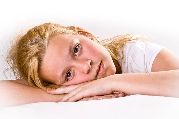 Attractive pre-teen looking at viewer stock photo