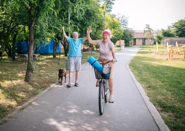 istock senior ride bikes and walk in the park 1521190861