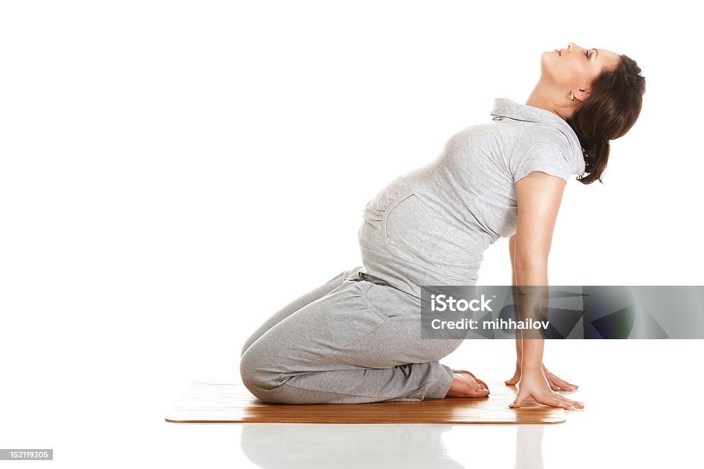 Pregnant woman practising aerobics Pregnant woman doing gymnastic exercises on isolated white background Pregnant Stock Photo