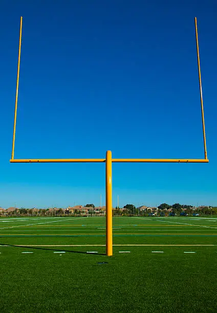 Uprights on a suburban football field with blue sky